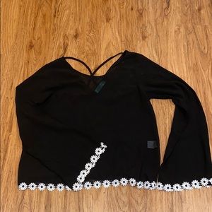 Black bell bottom sleeve top with floral detail